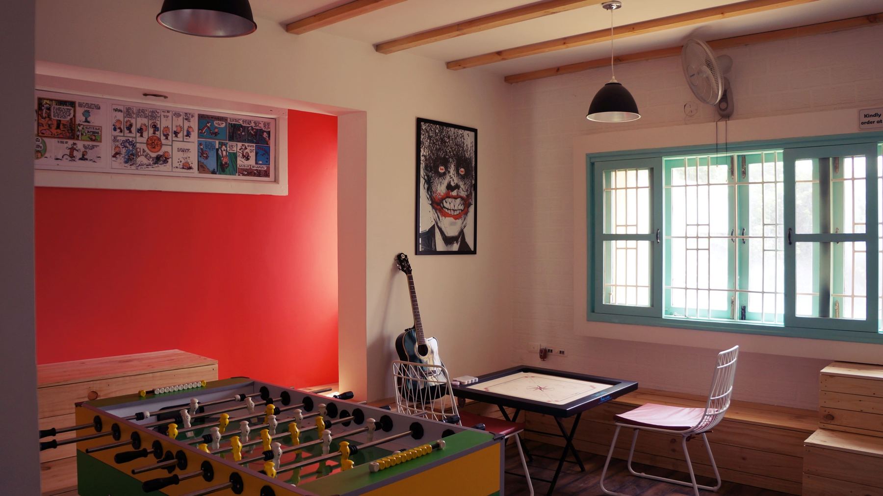 Foosball table against a red wall