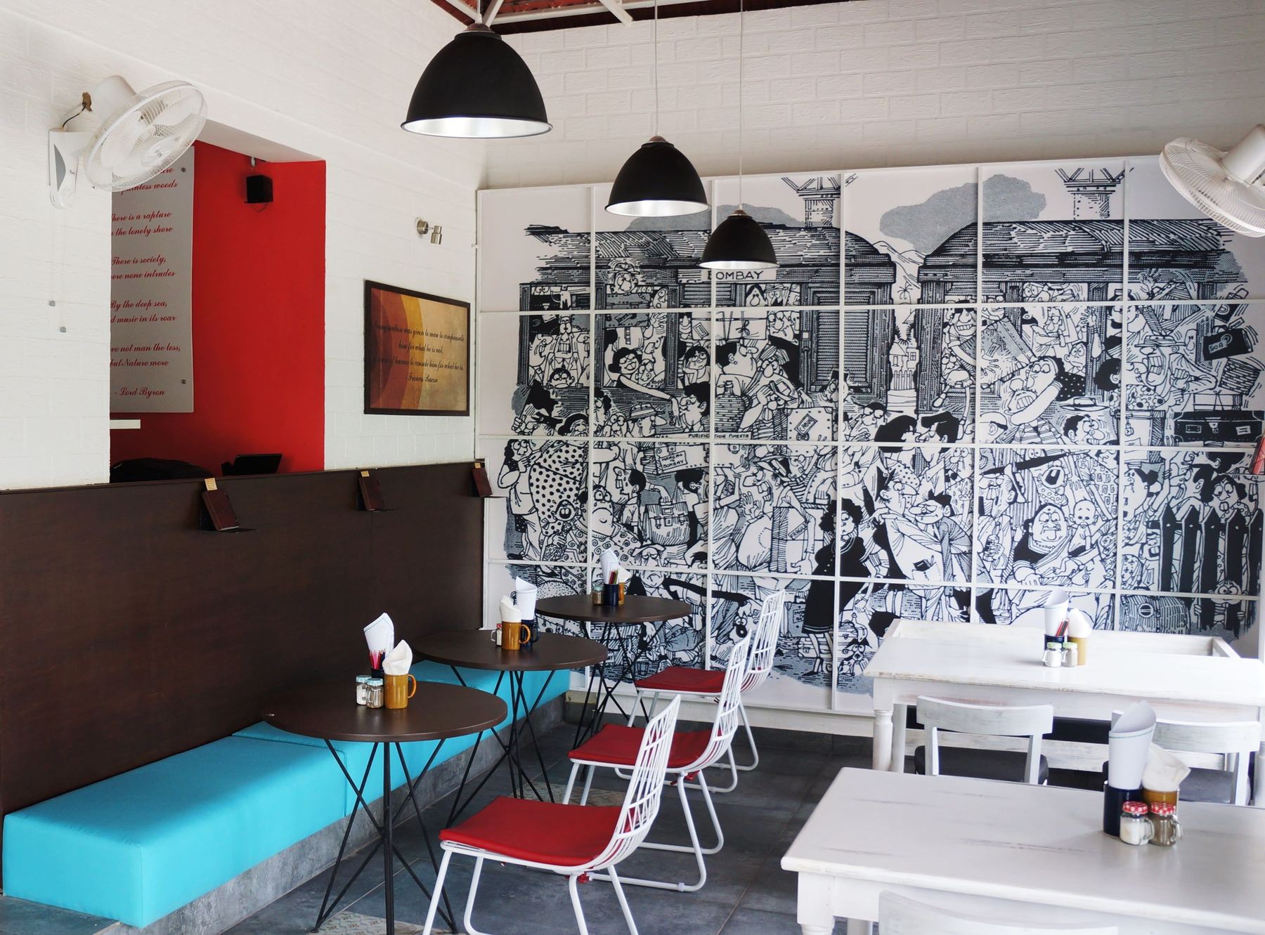 Mural wall and teal banquettes