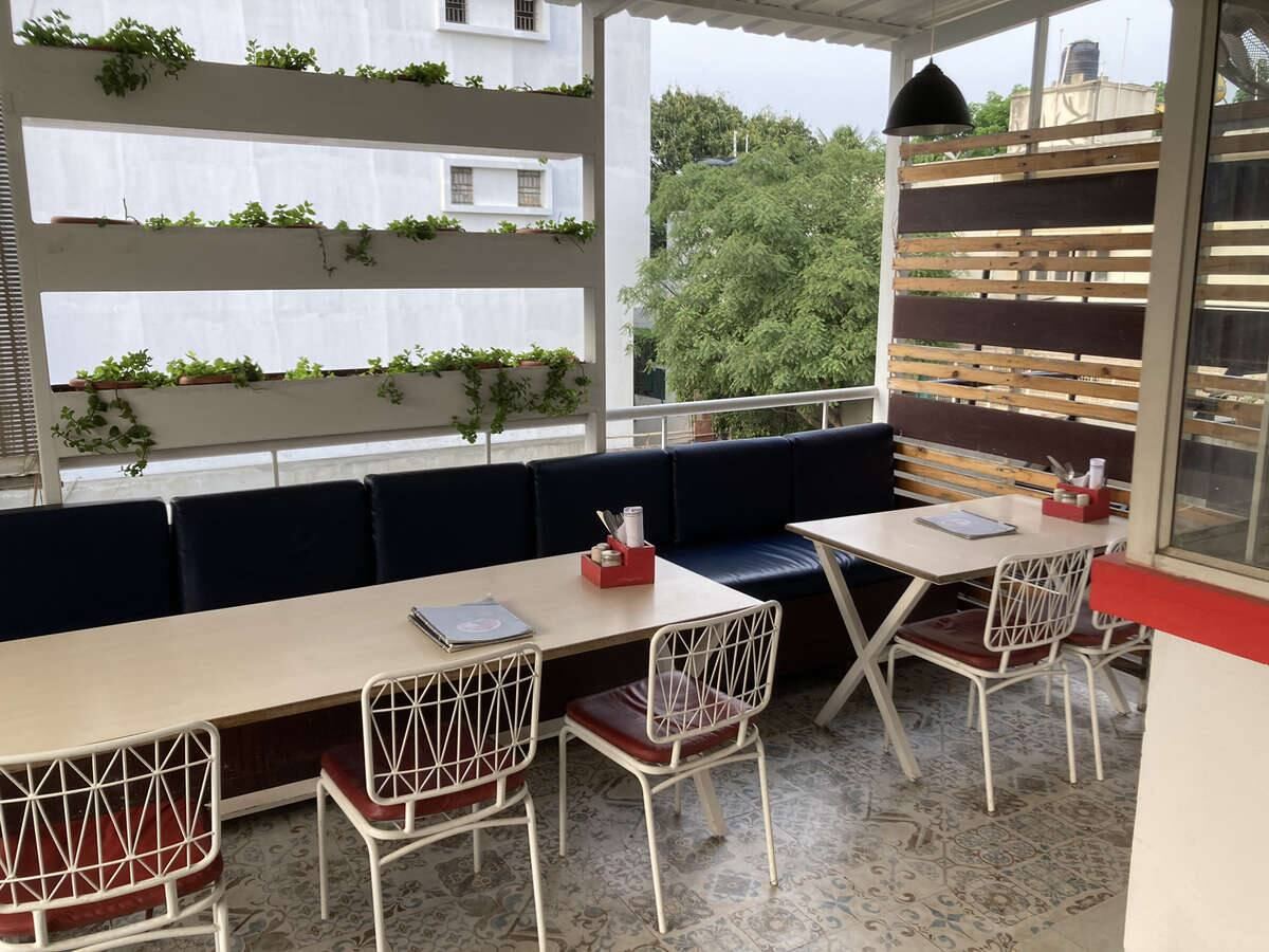 Long communal tables beside planter boxes