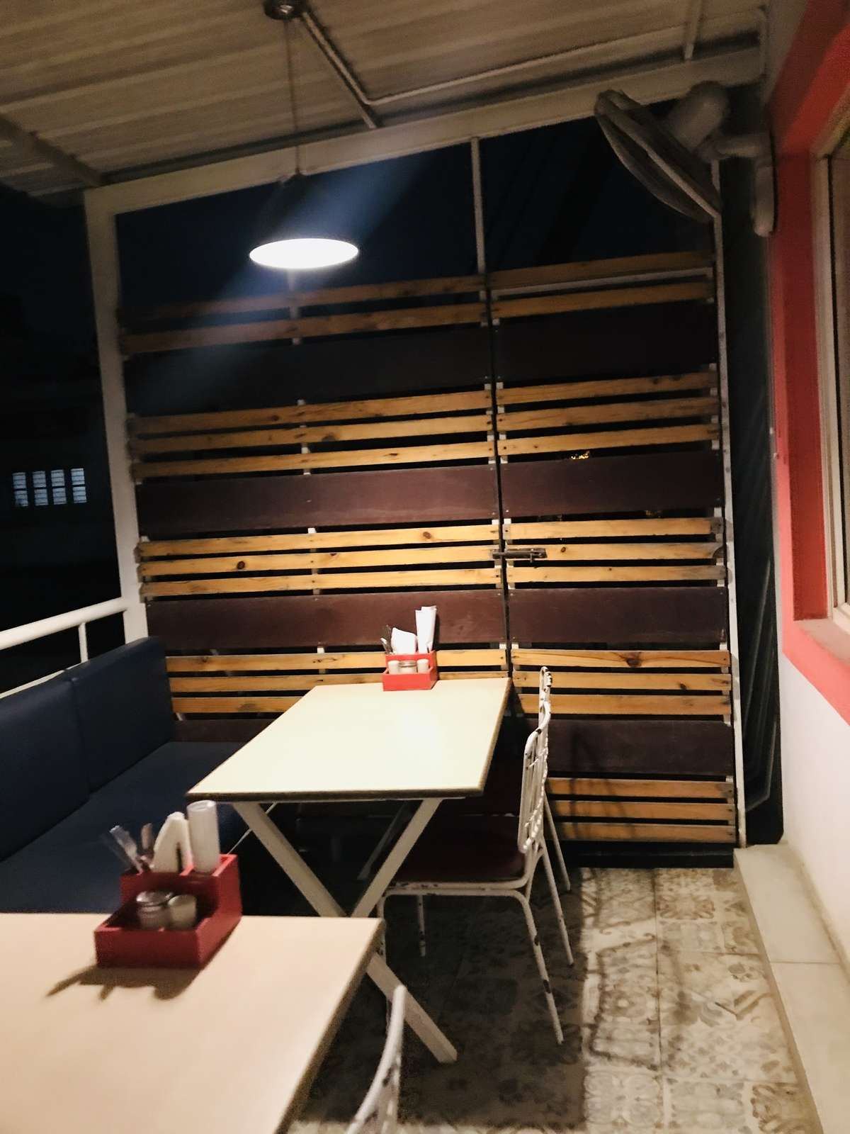 A booth against a dark timber slat wall
