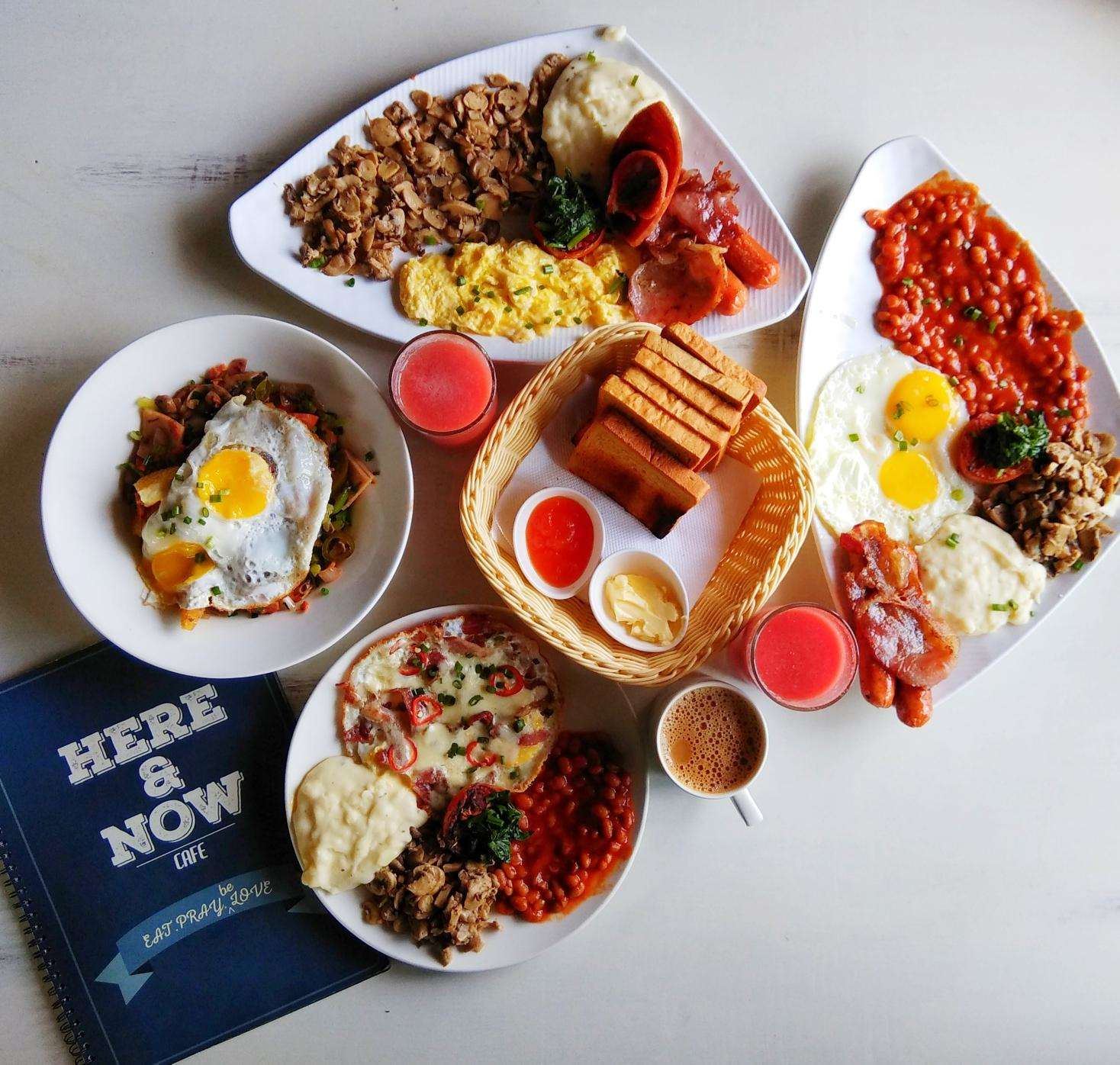 A full table of breakfast plates with a branded notebook